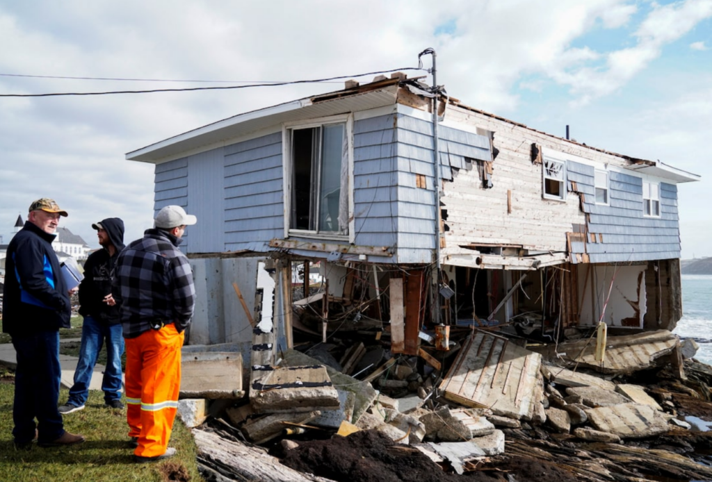 Severely damaged coastal home after storm surge and erosion