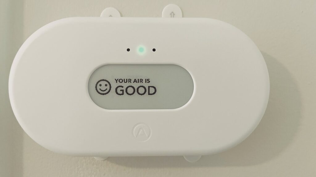 Indoor air quality monitor showing good air rating on display