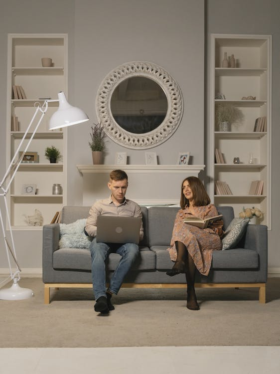 Two People Sitting on a Sofa
